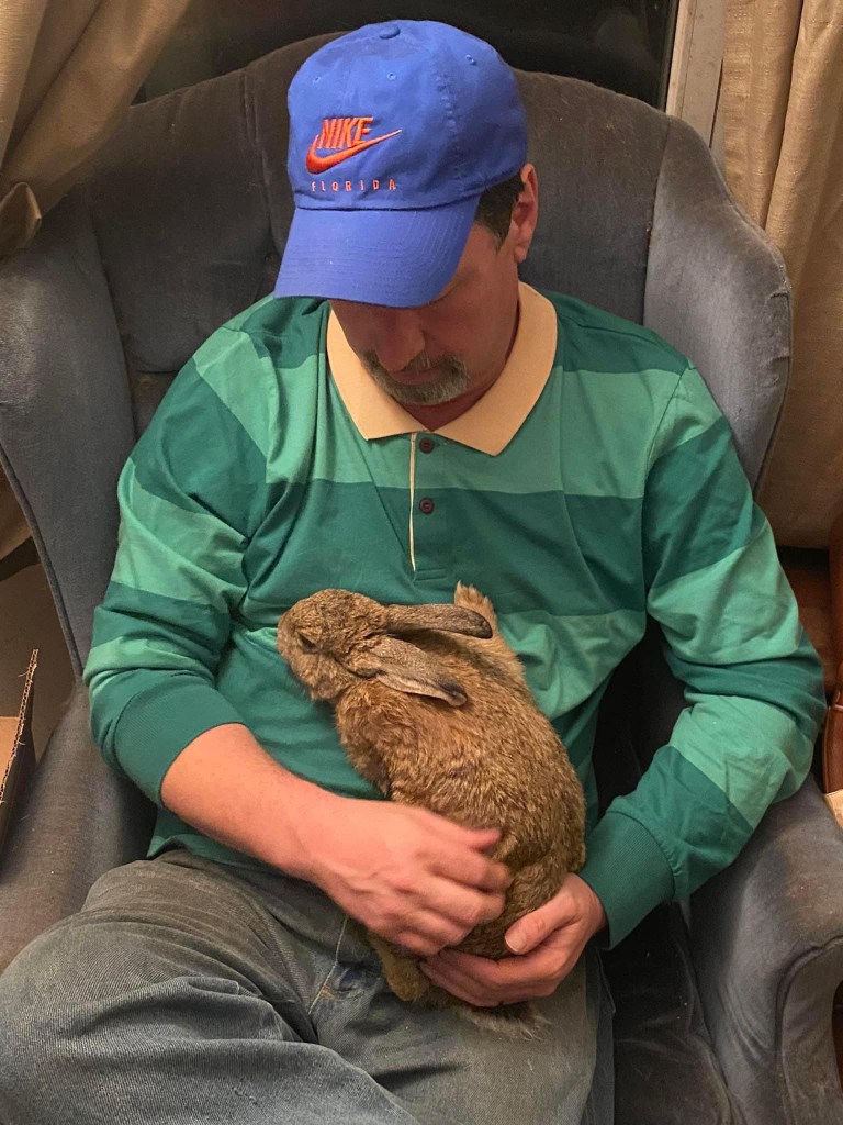 Man cuddling with a bunny 