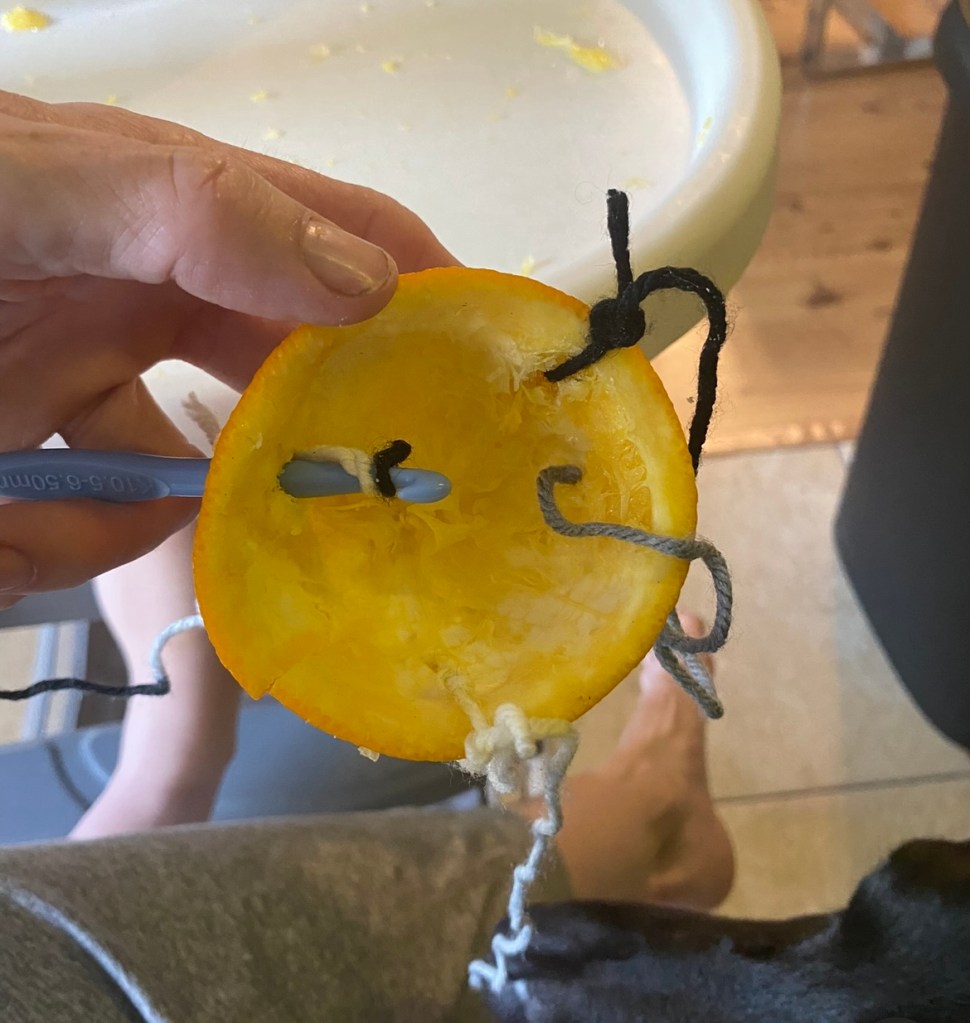 Orange with yarn and crochet hook