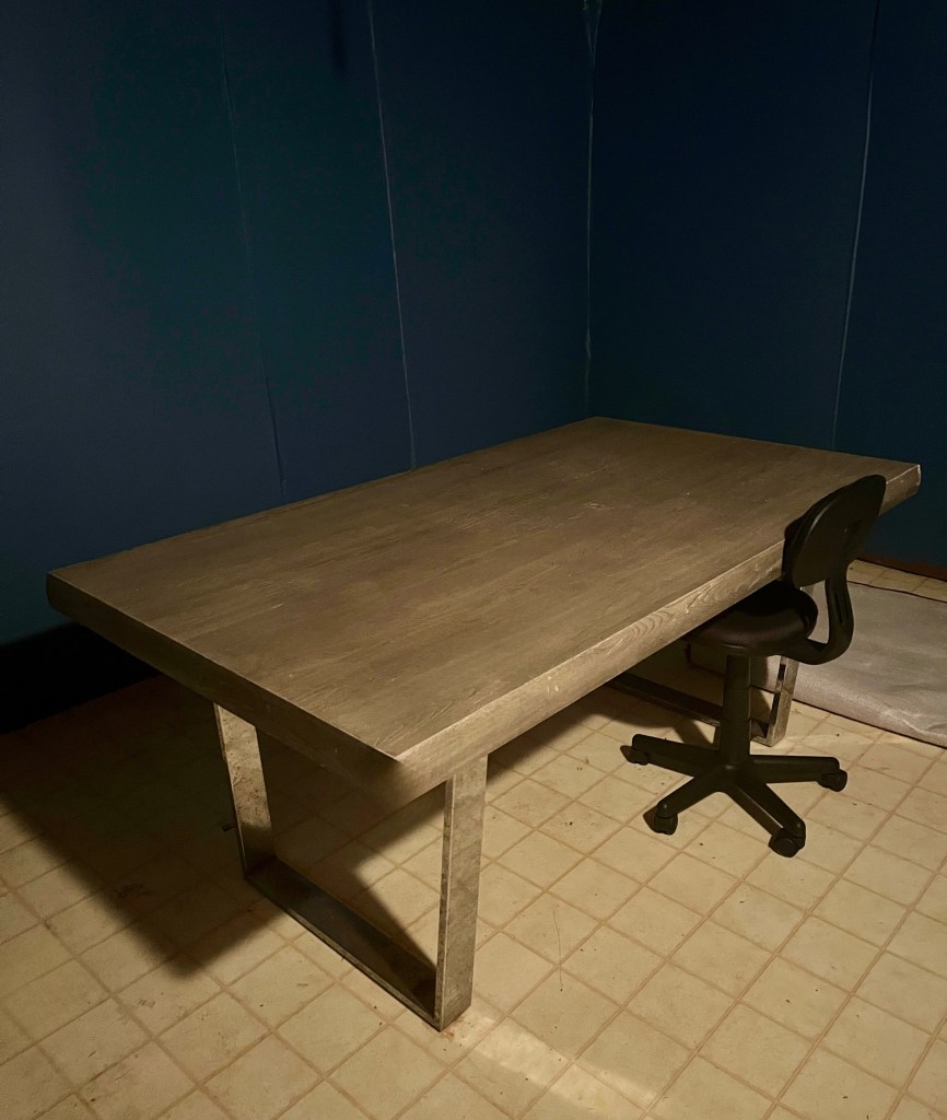 Picture of a dark room with a table and chair