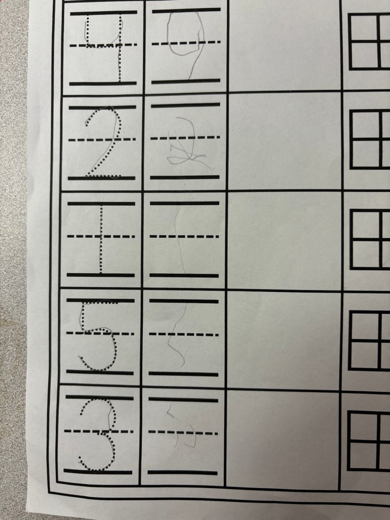 A worksheet showing numbers 0 to 9, with dotted lines for tracing and some handwritten attempts at writing the numbers.
